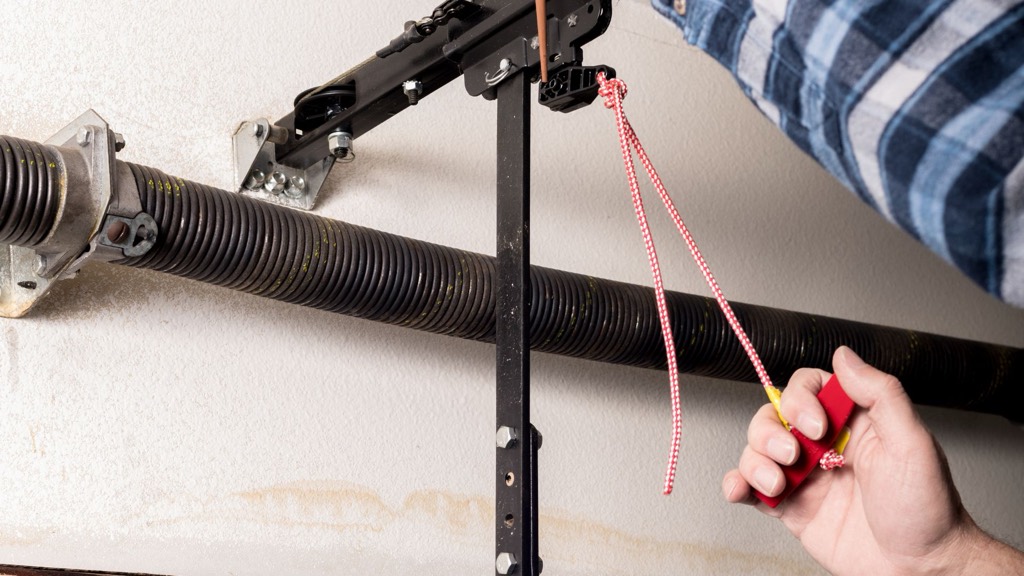 Corroded garage door spring and hardware affected by salt air in Estero, FL